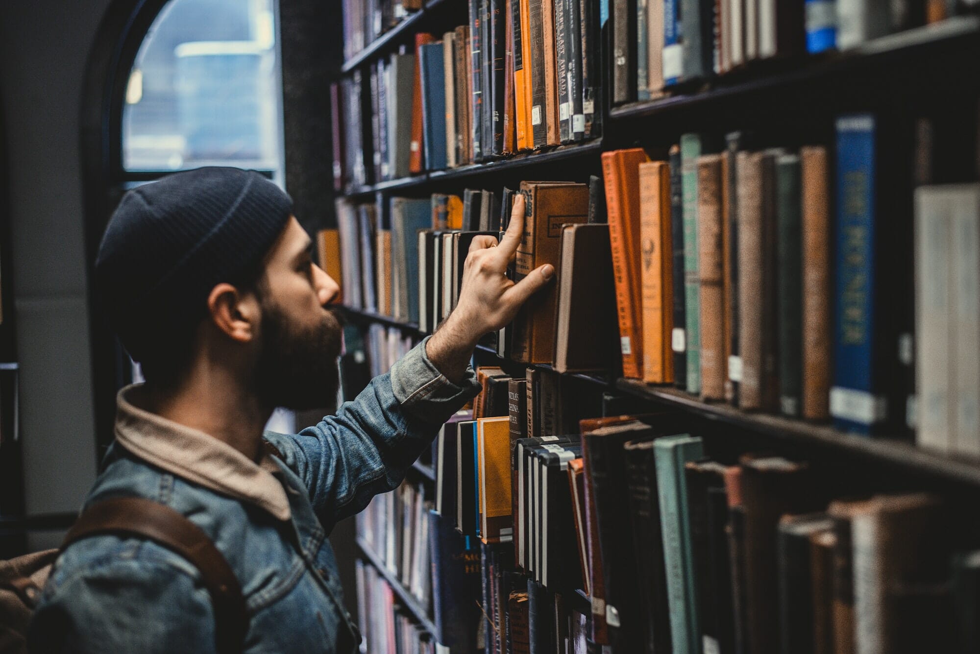 Customer browses books in the library.