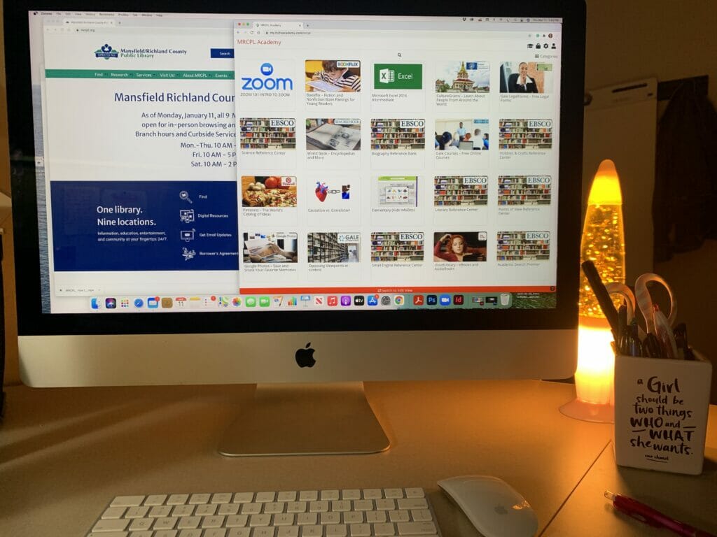 A Mac desktop computer screen sits on a desk with Niche Academy displayed on the screen.