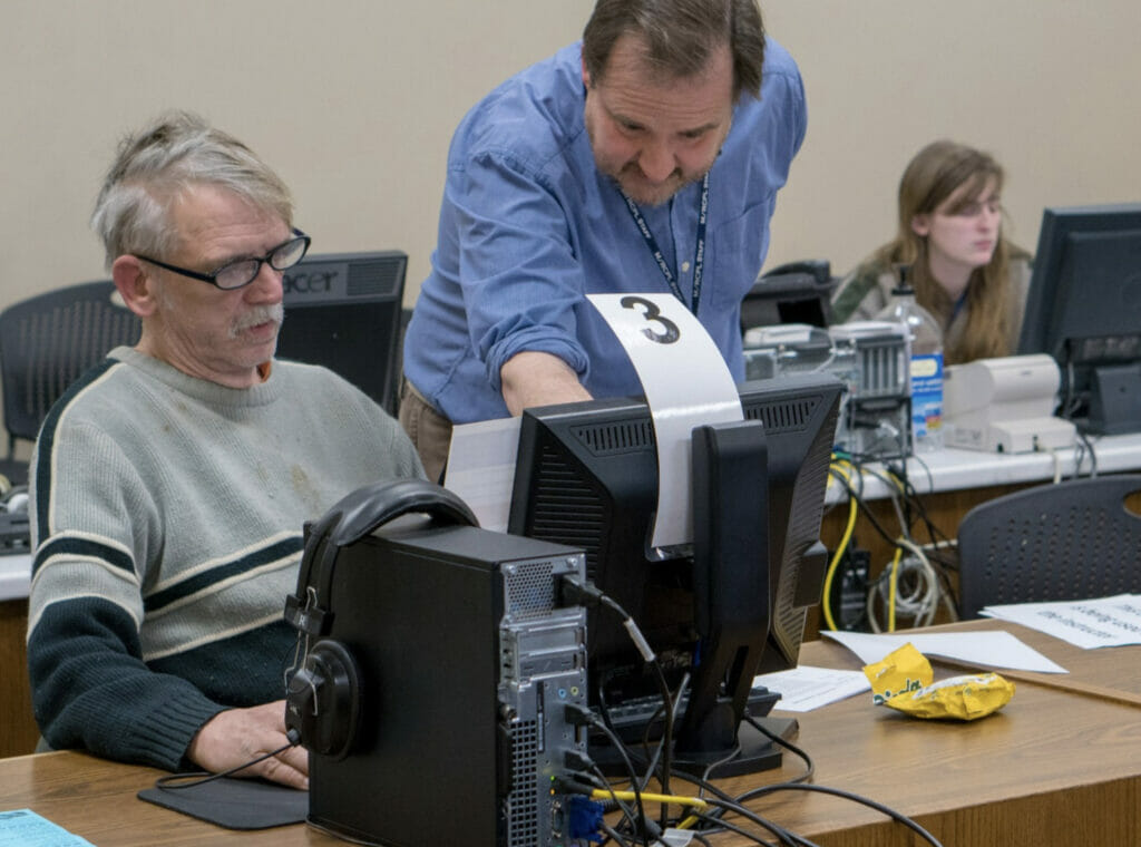 A staff member assists a customer in the Learning Lab at the Main Library.
