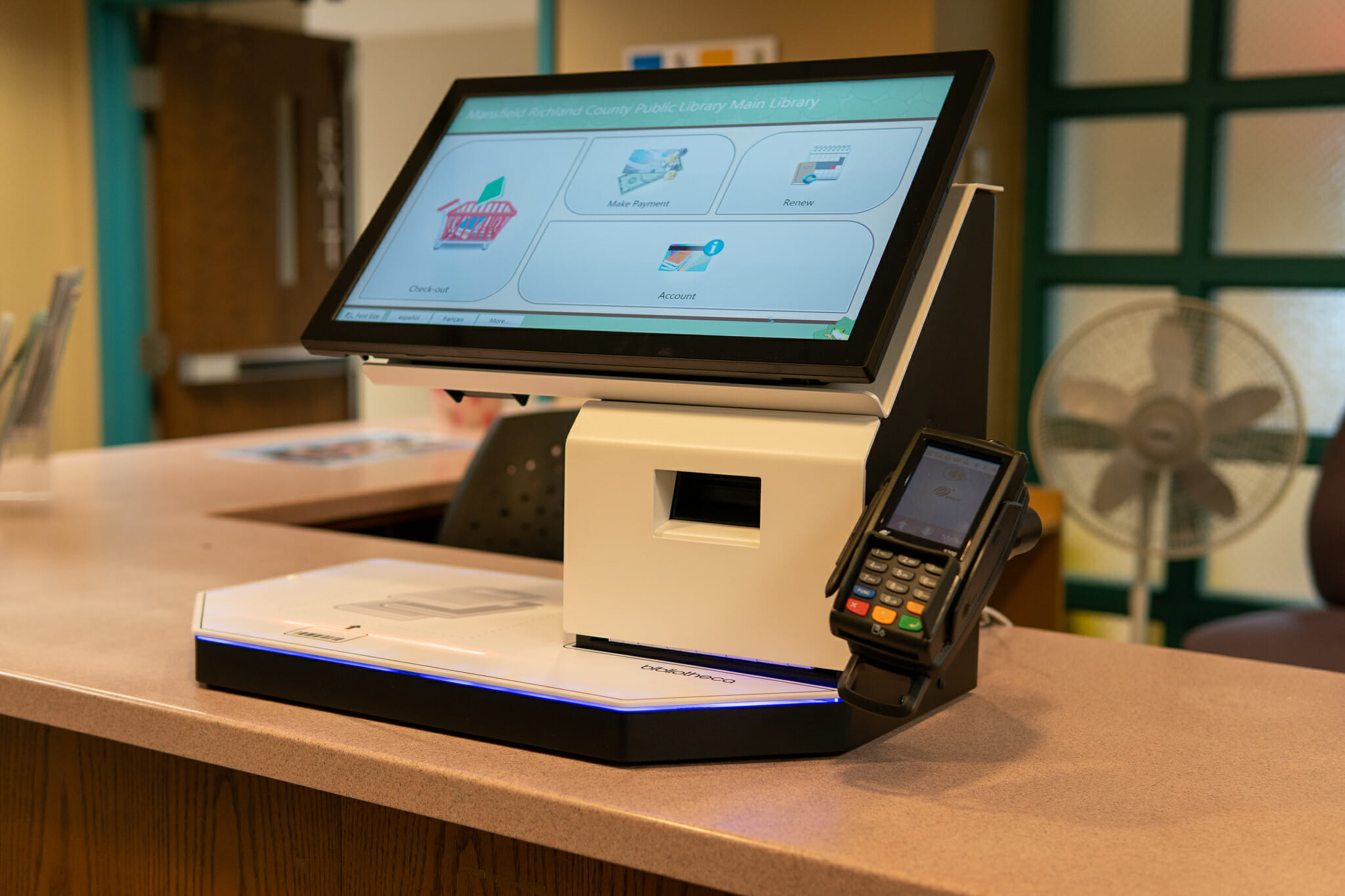 A close up of a library self checkout machine.