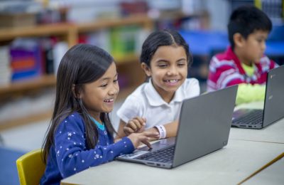 Young children work on computers.