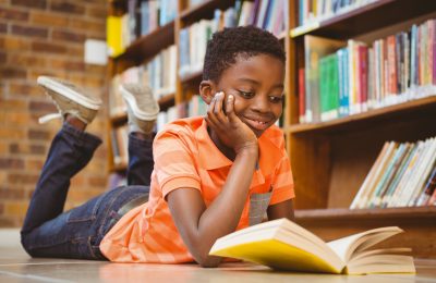 Child on floor reading book.